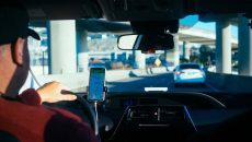 Driver navigating traffic while dealing with a defective vehicle issue under California Lemon Law